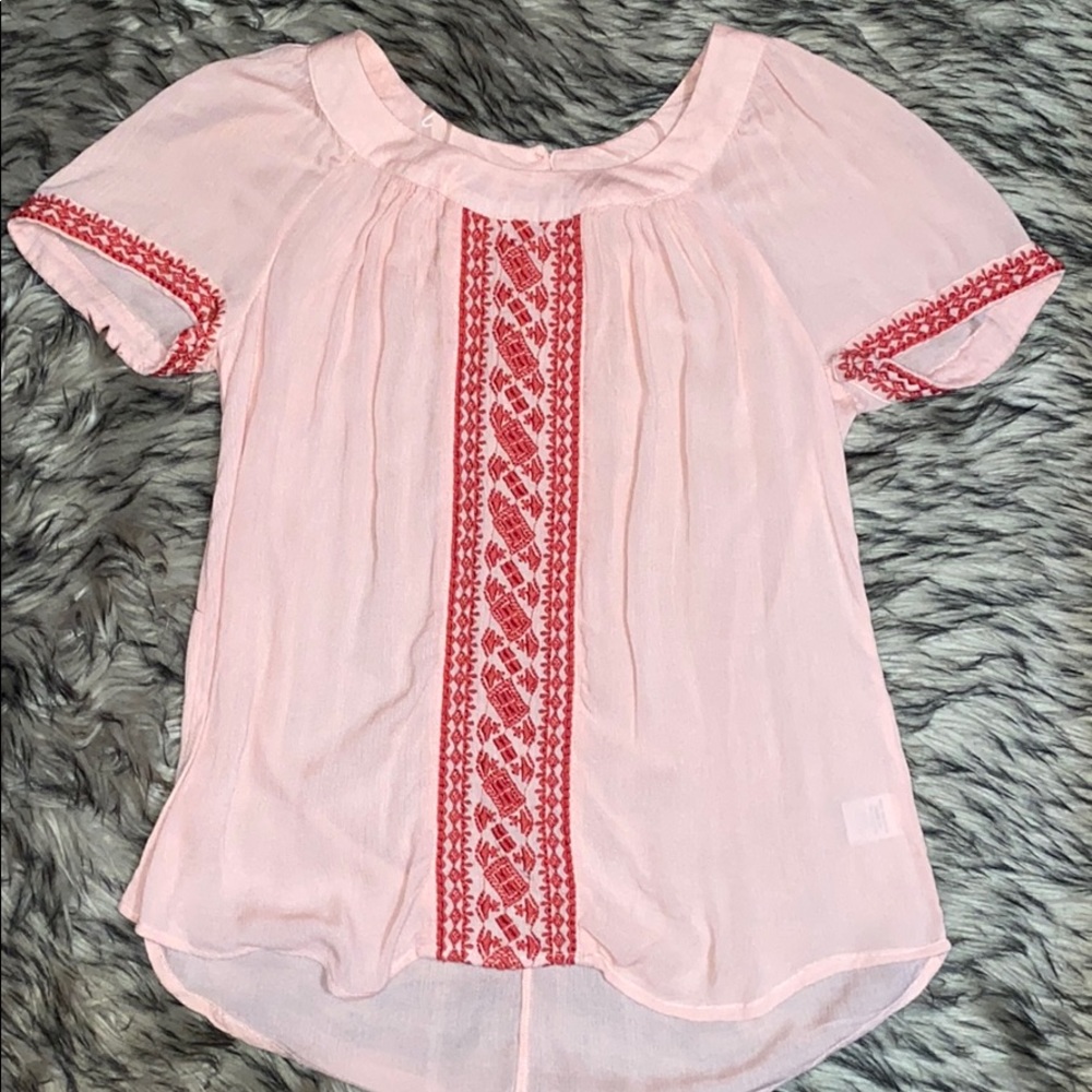 Pink shirt with red stitching
